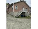 Back of the home with a staircase leading to a second-story deck, showcasing the home's design at 2509 Chapel Hill Rd, Durham, NC 27707