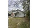 Quaint white home with a cozy covered front porch, surrounded by trees and a small, grassy lawn in a residential area at 2511 Chapel Hill Rd, Durham, NC 27707