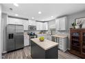 Modern kitchen featuring white cabinets, stainless steel appliances, and a dark island at 2604 Fortrose Ln, Fuquay Varina, NC 27526