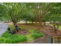 Secluded backyard featuring a fire pit, patio furniture, and mature trees at 275 Eagle Stone Rdg, Youngsville, NC 27596