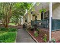Inviting front porch decorated with hanging plants and outdoor decor at 275 Eagle Stone Rdg, Youngsville, NC 27596