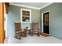 Inviting front porch featuring rocking chairs, neutral decor, and a welcoming entrance at 290 Quarter Gate Trce, Chapel Hill, NC 27516
