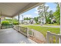 View from front porch with white railings, showing neighborhood street and well-kept lawns at 3114 Alabama Ave, Durham, NC 27705