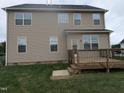 Back of home featuring a spacious backyard and a wooden deck, perfect for outdoor enjoyment and relaxation at 319 Brinkley Cir, Mebane, NC 27302