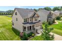 Attractive two-story home featuring brick and vinyl siding, an inviting front porch, and a green lawn at 319 Brinkley Cir, Mebane, NC 27302