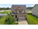 Charming two-story home with brick accents, a two-car garage, and a lush green lawn at 319 Brinkley Cir, Mebane, NC 27302