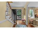 Inviting foyer features hardwood floors, staircase, and bright natural light at 3919 Wentworth Dr, Durham, NC 27707