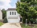Beautiful two-story home with a landscaped front yard and a paved driveway leading to an attached garage at 4234 Offshore Dr, Raleigh, NC 27610