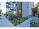 Street view of condo building with gray siding and a metal giraffe art display on the sidewalk at 515 N Mangum St # 41, Durham, NC 27701