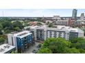 Modern apartment building featuring multiple floors and a sleek design, surrounded by lush trees at 515 N Mangum St # 41, Durham, NC 27701