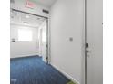 Hallway leading to an apartment door, showcasing modern carpeting and neutral wall colors at 515 N Mangum St # 41, Durham, NC 27701