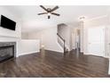 Spacious living room featuring hardwood floors, a stone fireplace, and neutral paint colors at 57 S Shreve Dr, Wendell, NC 27591