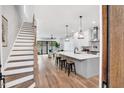 Open floor plan features a modern kitchen with a large island and staircase at 606 Velma Hopkins Ln, Raleigh, NC 27603