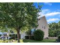 Side view of a lovely home with well-kept lawn and mature trees, creating a serene and inviting outdoor space at 609 Redford Place Dr, Rolesville, NC 27571