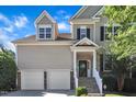 Beautiful home with a two-car garage and stone-accented front, offering a blend of modern convenience and classic design at 609 Redford Place Dr, Rolesville, NC 27571