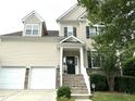 Charming two-story home featuring a welcoming front porch, two-car garage and well-maintained landscaping at 609 Redford Place Dr, Rolesville, NC 27571