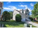 Well-maintained home with a two-car garage and lush landscaping on a sunny day, showcasing suburban charm and curb appeal at 609 Redford Place Dr, Rolesville, NC 27571