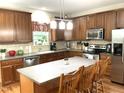 Beautiful kitchen with wooden cabinets, stainless steel appliances, a center island, and a window over the sink at 609 Redford Place Dr, Rolesville, NC 27571