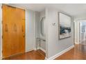 Light-filled foyer featuring wood floors, a glass console table, and art at 620 Martin Luther King Jr. Blvd # 302, Chapel Hill, NC 27514