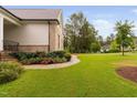 Well-manicured lawn and landscaped garden with flowering bushes at 623 Cabin Crk, Pittsboro, NC 27312