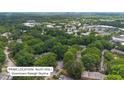 North Hills/Downtown Raleigh skyline aerial view of neighborhood nestled in lush tree canopy on a sunny day at 6423 New Market Way, Raleigh, NC 27615