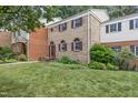 Charming brick townhome with a well-manicured front lawn and garden, featuring mature landscaping at 6423 New Market Way, Raleigh, NC 27615
