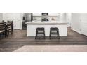 The kitchen features an island with seating and a view into the dining area at 704 Blazer Bnd, Wendell, NC 27591
