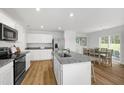 Open kitchen with stainless steel appliances, granite countertops and adjacent dining area at 708 Blazer Bnd, Wendell, NC 27591