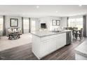 Open concept kitchen with stainless steel appliances, granite countertops, and an island at 712 Blazer Bnd, Wendell, NC 27591