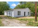 Charming home featuring white siding and neatly maintained landscaping, offering a serene curbside appeal at 714 Harriett St, Henderson, NC 27536