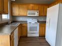 Functional kitchen with light wood cabinetry, white appliances, and durable countertops at 78 Ariel Street, Lillington, NC 27546