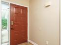Welcoming entryway featuring a paneled front door, neutral wall color, and hardwood floors at 8204 Charlbert Ct, Apex, NC 27539