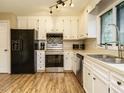 Bright kitchen with stainless steel appliances, lots of cabinet storage, and a stainless steel sink at 8204 Charlbert Ct, Apex, NC 27539