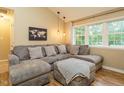 Comfortable living room featuring a large sectional sofa, natural light, and hardwood floors at 8204 Charlbert Ct, Apex, NC 27539