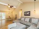 Open-concept living room with vaulted ceilings, hardwood floors, and comfortable seating area at 8204 Charlbert Ct, Apex, NC 27539