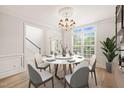 Elegant dining room featuring a round table, modern chairs, and natural light at 85 Pebble Creek Dr, Franklinton, NC 27525