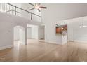 Open concept living space with tall ceilings, wood floors and archway to the kitchen area at 85 Pebble Creek Dr, Franklinton, NC 27525