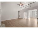 Open-concept living space featuring hardwood floors, high ceilings and a wrought iron railing at 85 Pebble Creek Dr, Franklinton, NC 27525
