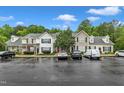 A full view of the parking lot for the townhome community, with mature trees at 8611 London Park Ct, Raleigh, NC 27615