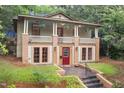 Beautiful two-story home with a cozy porch and a well-maintained yard, enhanced by a vibrant red door at 1008 Dorothea Dr, Raleigh, NC 27603