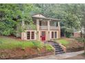 Charming two-story home featuring a front porch with manicured landscaping and a red front door at 1008 Dorothea Dr, Raleigh, NC 27603