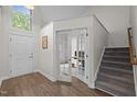 Open foyer with a staircase and double doors leading to an office at 103 Lake Tillery Dr, Cary, NC 27519