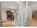 Elegant foyer with a staircase, hardwood floors, and a view of the dining room at 103 Rose Sky Ct, Cary, NC 27513