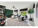 Bright living room with a dining table, plush seating, modern decor, and large windows overlooking greenery at 10538 Pleasant Branch Dr # 28, Raleigh, NC 27614