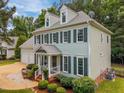 Well-maintained two-story home with pristine siding and landscaped front yard featuring lush green shrubbery at 106 Fawley Ct, Cary, NC 27519