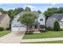 Inviting home with a two-car garage, blossoming tree, and meticulously maintained front yard at 106 Painted Turtle Ln, Cary, NC 27519