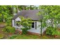 A beautiful view of this home's architecture surrounded by lush greenery at 1105 Hawthorne Ln, Burlington, NC 27215