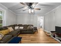 Inviting living room with hardwood floors, a ceiling fan, and a calming color palette at 1105 Hawthorne Ln, Burlington, NC 27215