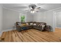 Cozy living room with hardwood floors, a ceiling fan, and lots of natural light at 1105 Hawthorne Ln, Burlington, NC 27215