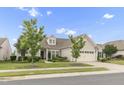 Beautiful one-story home featuring a well-kept lawn, tidy landscaping, and a two-car garage at 118 Manning Way, Durham, NC 27703